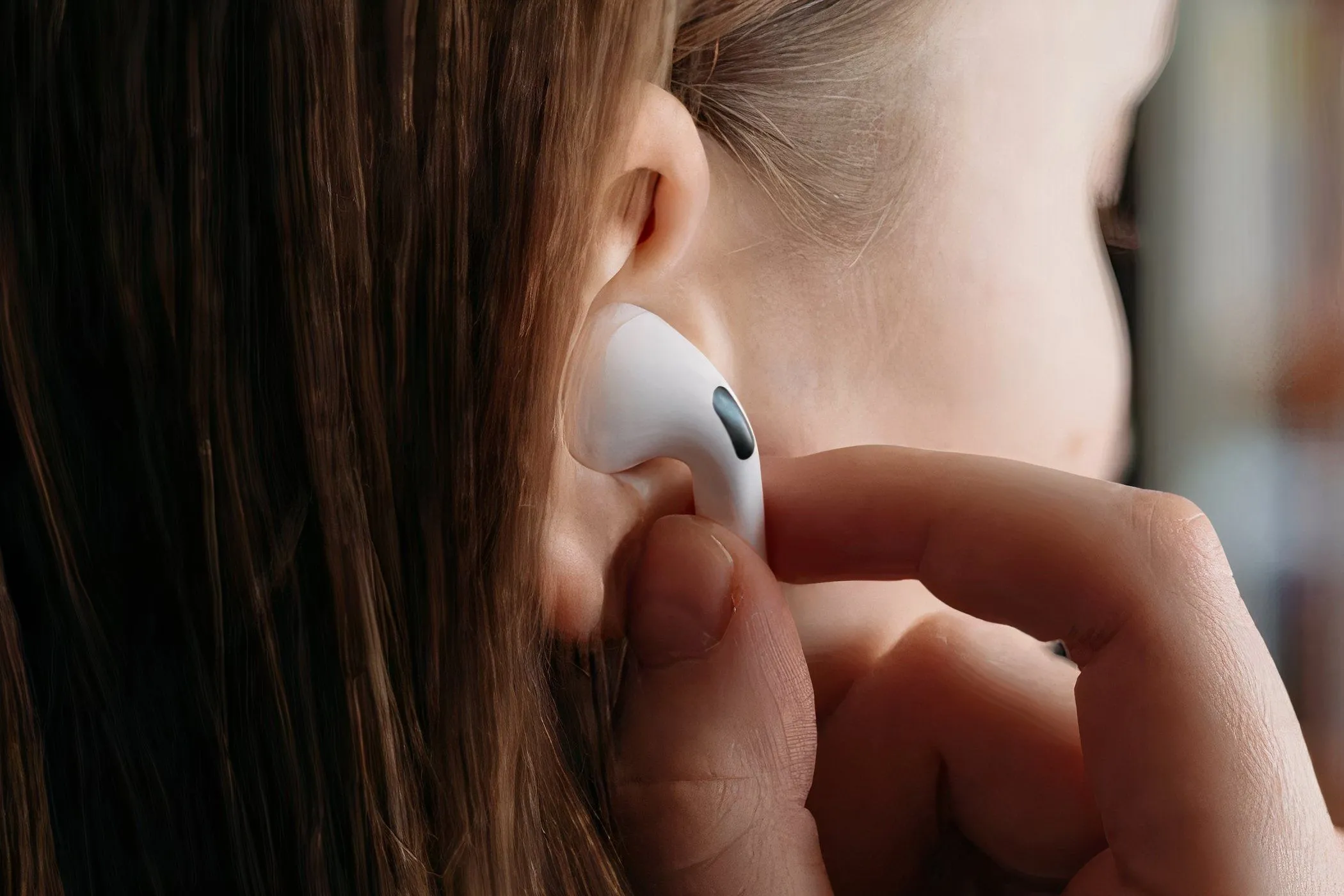 Người phụ nữ đeo tai nghe AirPods Pro vào tai, trải nghiệm sự tiện lợi của âm thanh không dây.